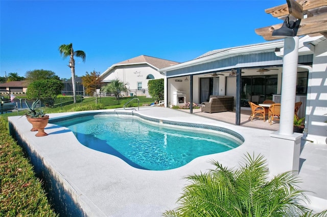 view of swimming pool with a fireplace, a patio, and ceiling fan