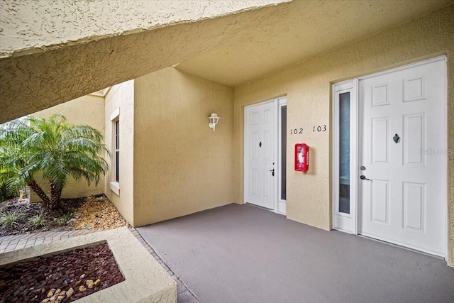 entrance to property featuring a patio