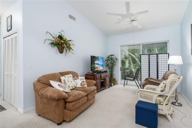 living room with carpet flooring, ceiling fan, and lofted ceiling