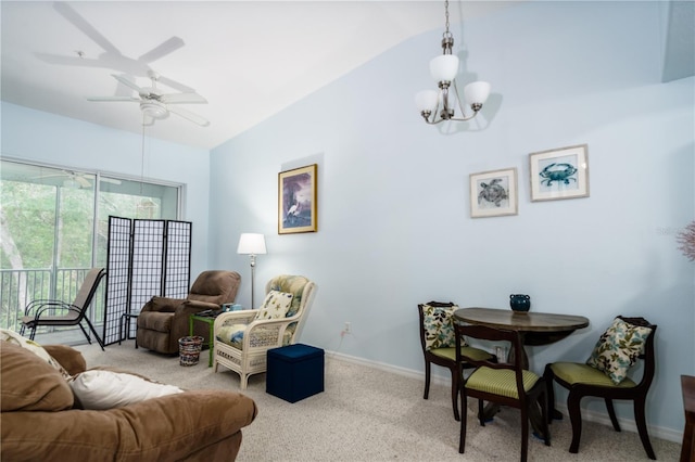 carpeted living room featuring ceiling fan with notable chandelier and vaulted ceiling