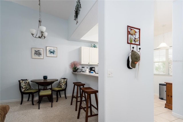 carpeted dining space with an inviting chandelier