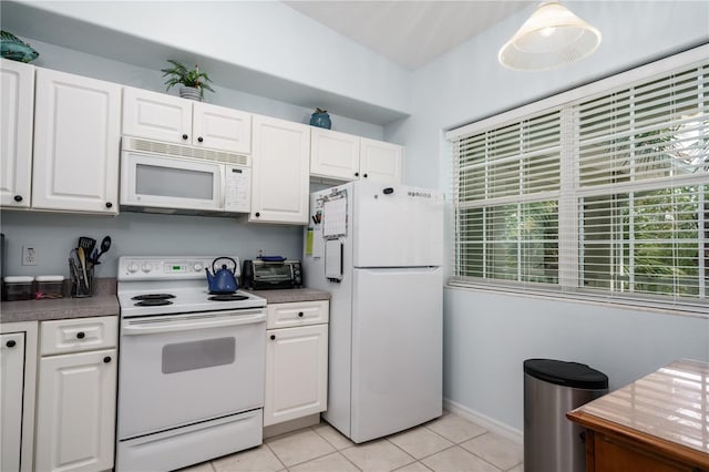 kitchen featuring white appliances, white cabinetry, and light tile patterned flooring