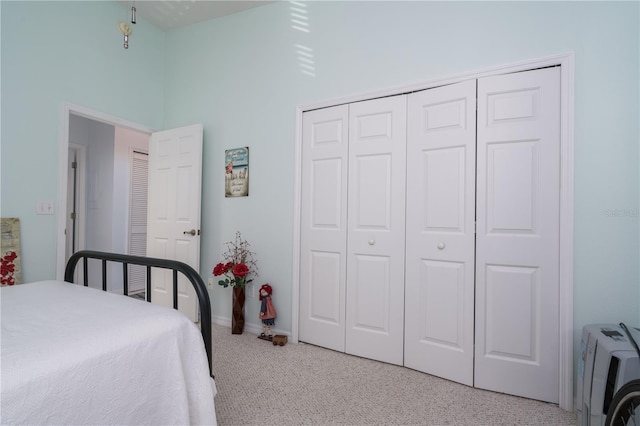 bedroom with light carpet, a high ceiling, and a closet