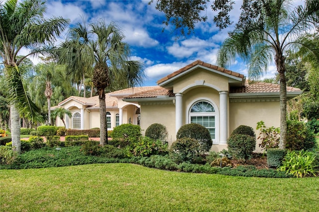 mediterranean / spanish-style house featuring a front yard