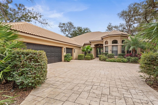 mediterranean / spanish home featuring a garage