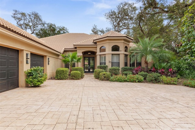 view of front of property featuring french doors and a garage