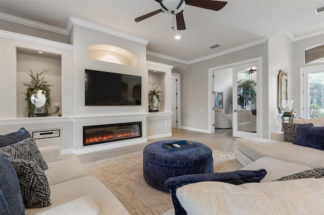 living room with ceiling fan and crown molding