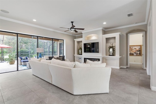 living room with ceiling fan and ornamental molding