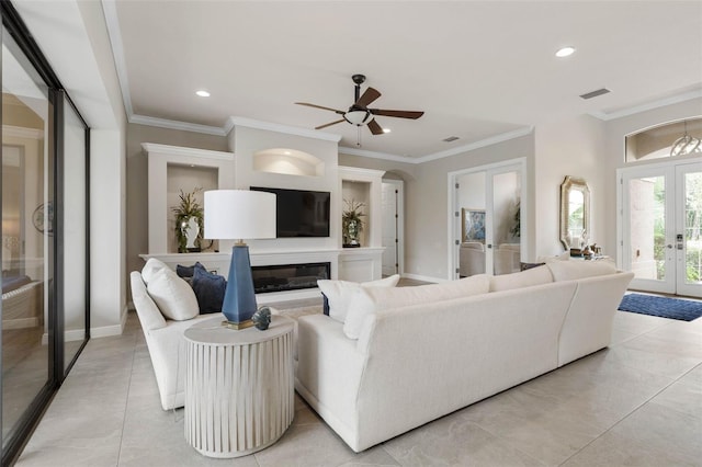 tiled living room featuring ceiling fan, ornamental molding, and french doors