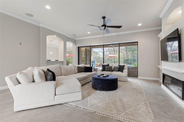 living room with ceiling fan, light tile patterned floors, and ornamental molding