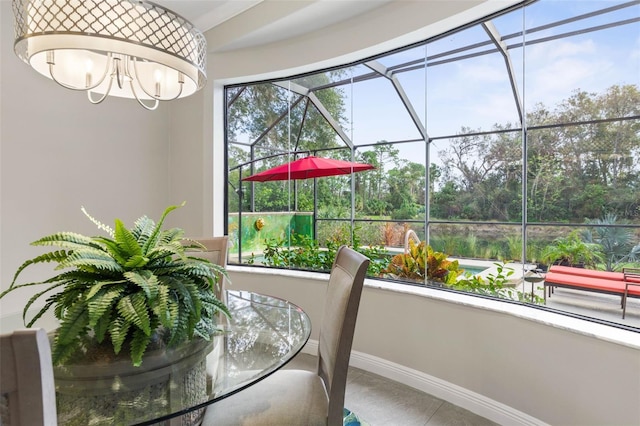 sunroom / solarium featuring a notable chandelier