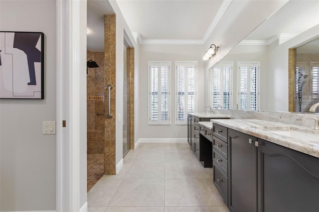 bathroom with tile patterned flooring, vanity, tiled shower, and ornamental molding