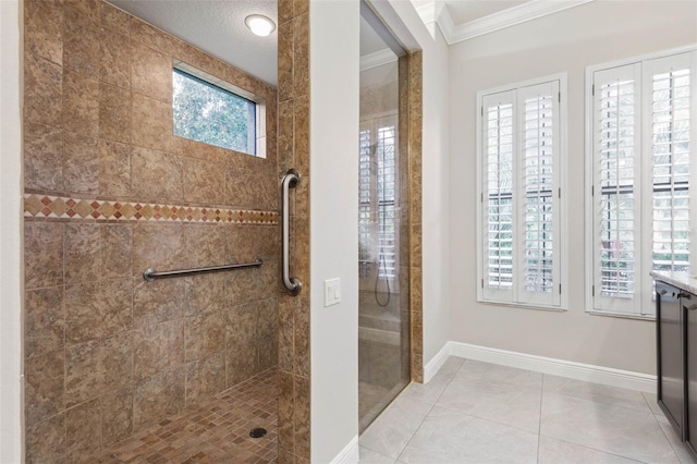 bathroom with a tile shower, crown molding, tile patterned flooring, and a textured ceiling