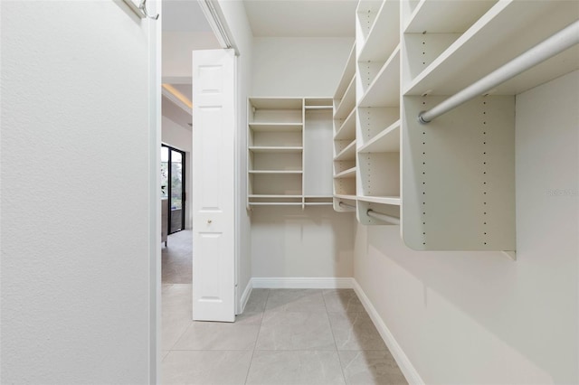 spacious closet with light tile patterned floors