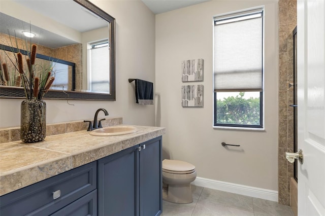 bathroom featuring tile patterned floors, vanity, toilet, and tiled shower