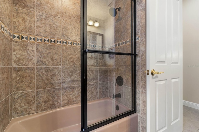 bathroom featuring combined bath / shower with glass door