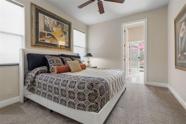 bedroom featuring carpet floors, multiple windows, and ceiling fan