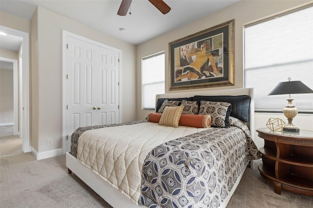 carpeted bedroom featuring a closet and ceiling fan