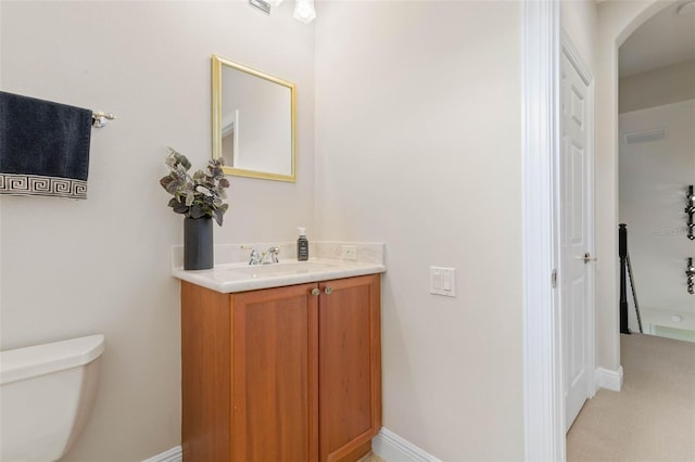 bathroom featuring vanity and toilet