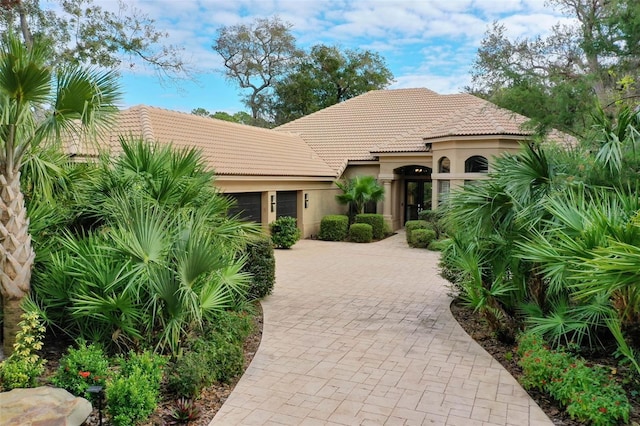 mediterranean / spanish-style home with a garage