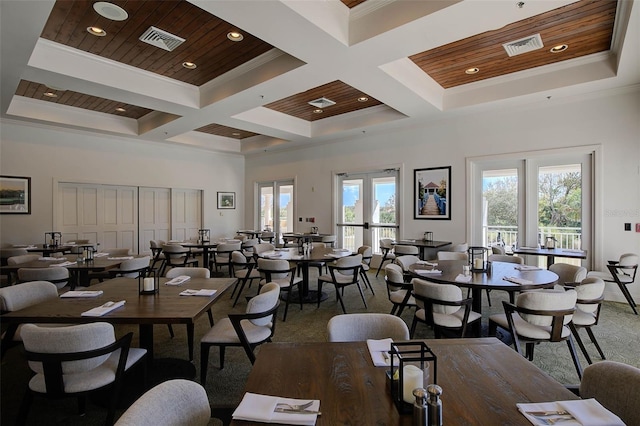 dining space with a high ceiling, wooden ceiling, crown molding, and coffered ceiling