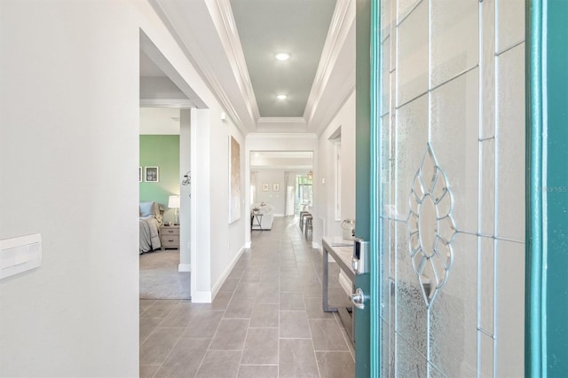 hall with light tile patterned floors and ornamental molding