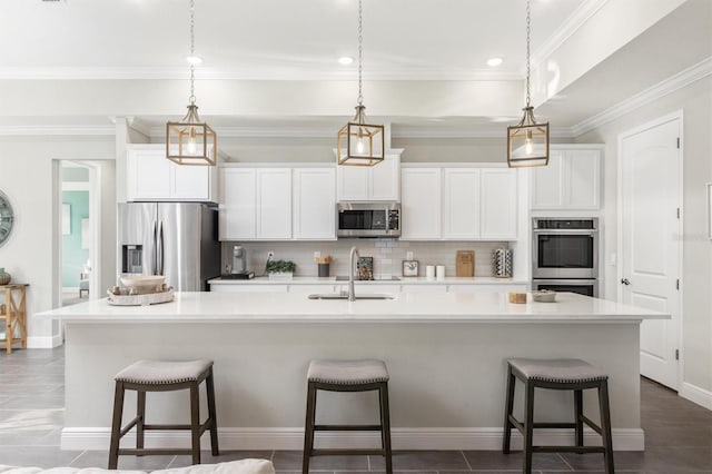 2214 Elegant Manor Cir, Edgewater, FL 32141 - kitchen with appliances with stainless steel finishes, tasteful backsplash, a large island with sink, white cabinets, and crown molding