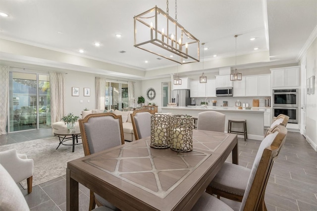 dining space featuring a raised ceiling and ornamental molding