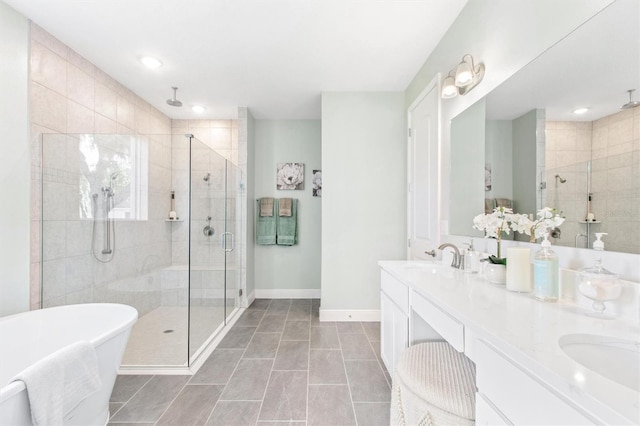 bathroom with tile patterned floors, vanity, and separate shower and tub