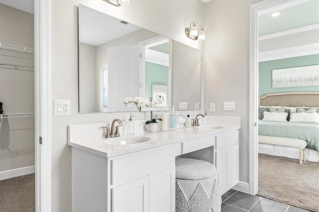 2214 Elegant Manor Cir, Edgewater, FL 32141 - ensuite bathroom featuring double vanity, a walk in closet, and tile patterned floors
