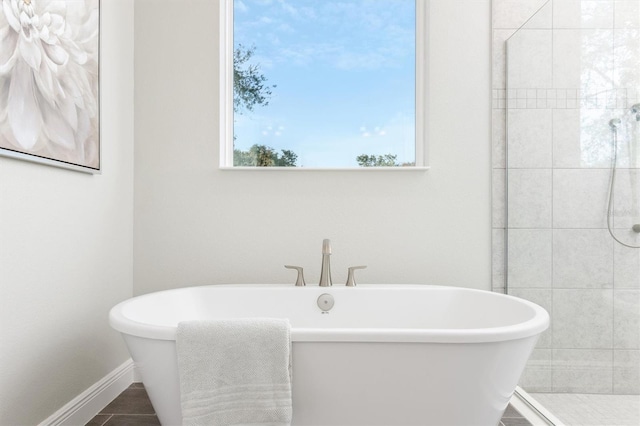 bathroom with separate shower and tub and tile patterned floors