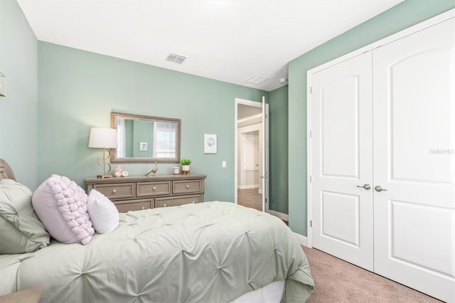 bedroom with light carpet and a closet