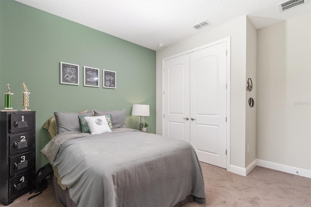 bedroom featuring a closet and light colored carpet