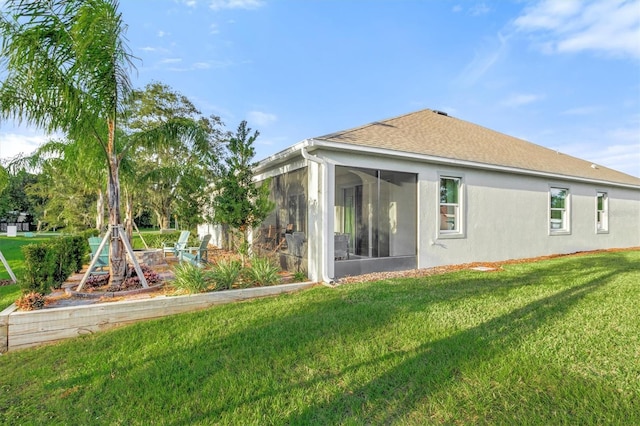 2214 Elegant Manor Cir, Edgewater, FL 32141 - back of property featuring a sunroom, a lawn, stucco siding, and roof with shingles