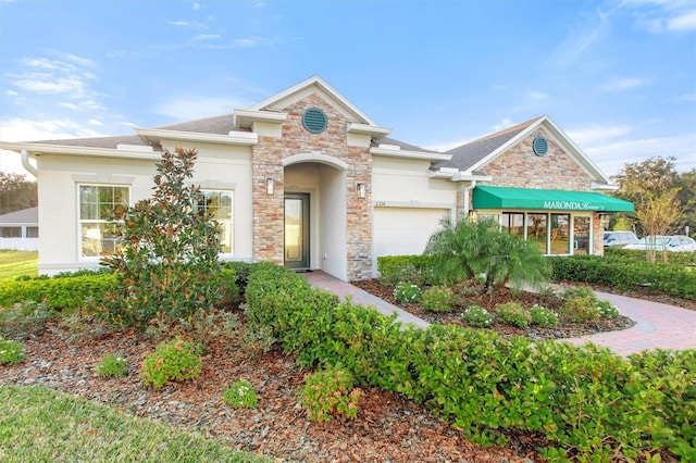 2214 Elegant Manor Cir, Edgewater, FL 32141 - traditional home featuring stone siding, a garage, and stucco siding
