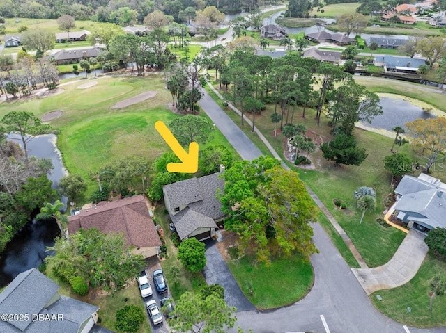 drone / aerial view featuring a residential view and a water view