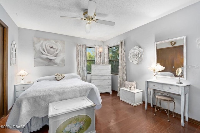 bedroom with ceiling fan, baseboards, a textured ceiling, and wood finished floors