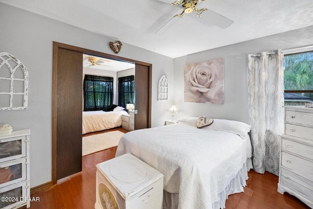 bedroom with baseboards, a ceiling fan, and wood finished floors