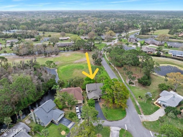 birds eye view of property featuring a wooded view and a residential view