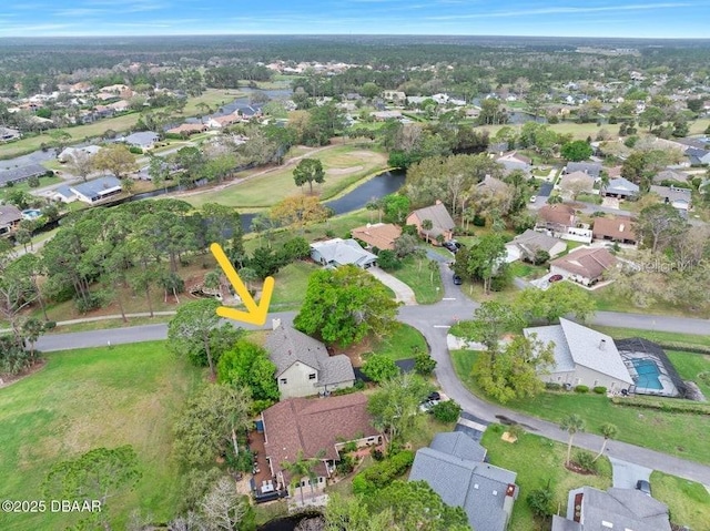 drone / aerial view with a residential view and a water view