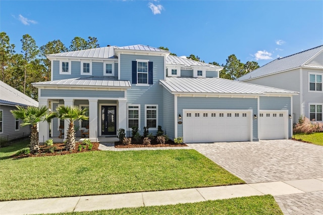 view of front of house featuring a front lawn and a garage