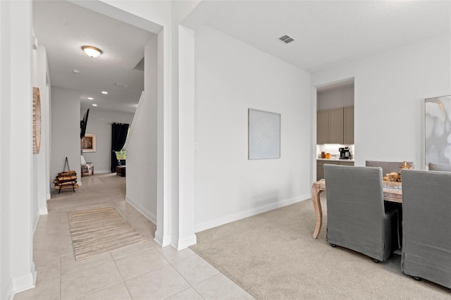 interior space with light carpet and a textured ceiling