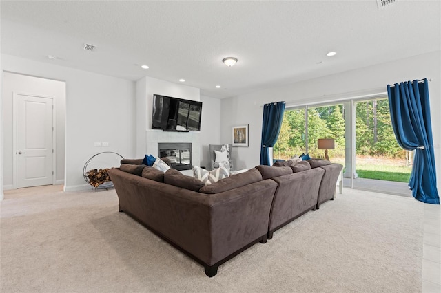 living room featuring light colored carpet and a textured ceiling