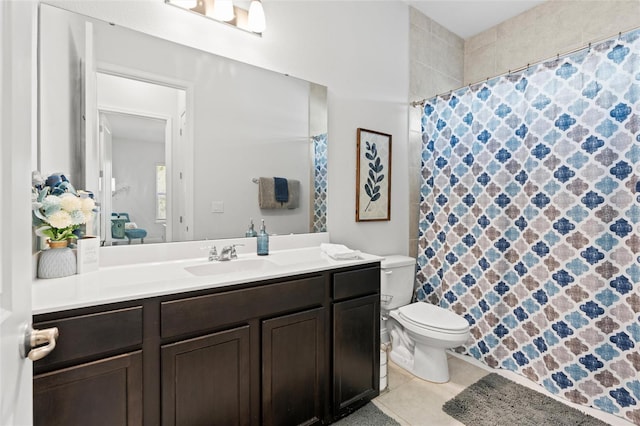 bathroom with tile patterned flooring, vanity, and toilet