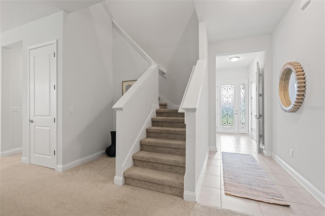 staircase featuring carpet flooring