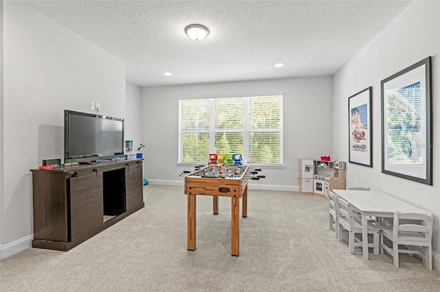 playroom with light carpet and a textured ceiling