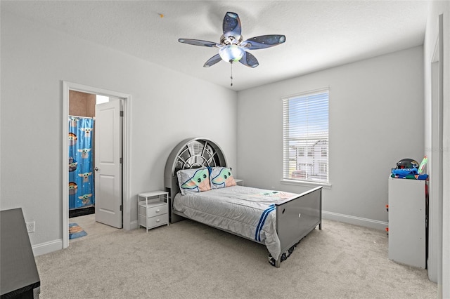 bedroom with light carpet, a textured ceiling, and ceiling fan