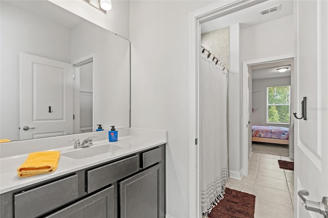 bathroom with tile patterned flooring, vanity, and a shower with curtain