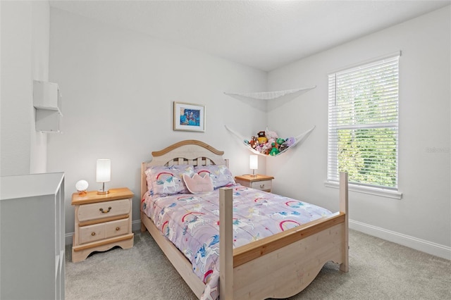 carpeted bedroom featuring multiple windows