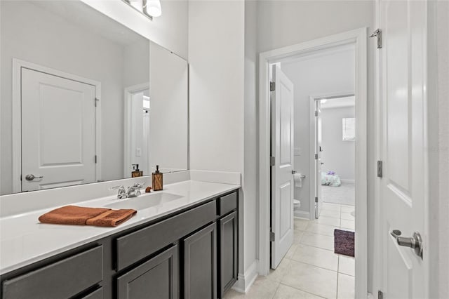 bathroom featuring toilet, vanity, and tile patterned floors